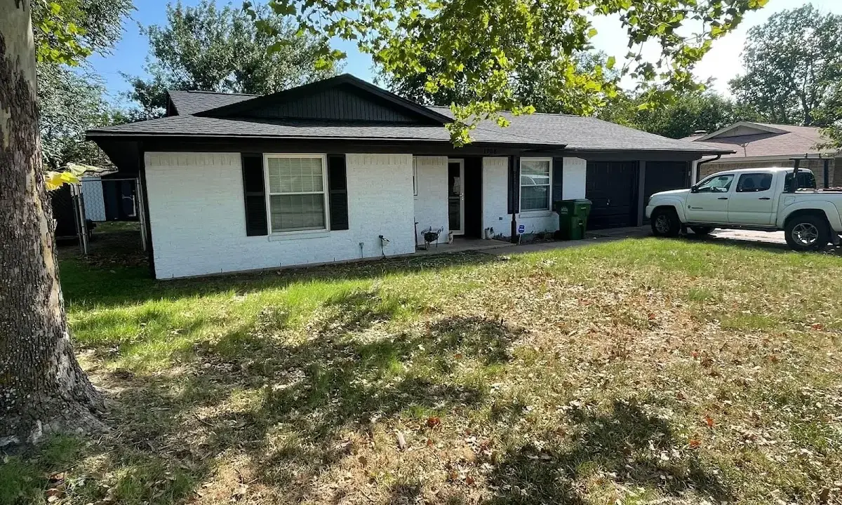 Professional roofing crew working on a residential roof in Pinewood